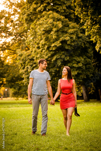 Young couple walking on grass
