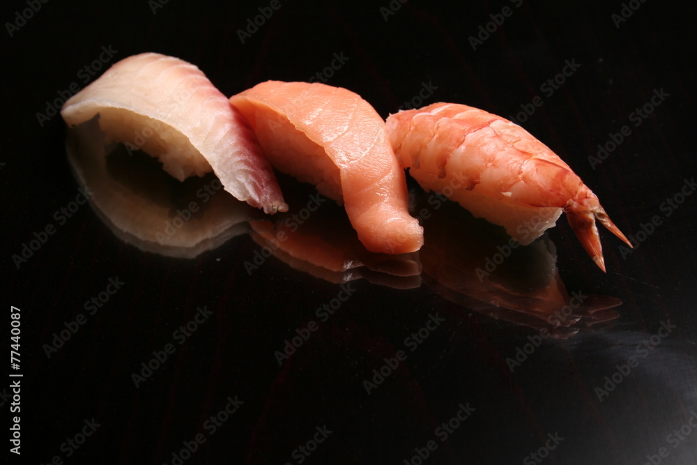 traditional sushi and sashimi on black background traditional sushi and sashimi on black background