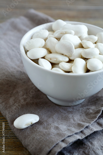 White beans in bowl on a linen napkin