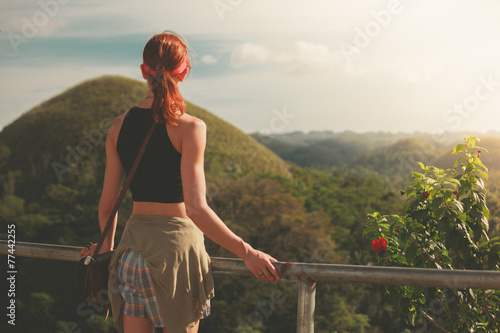 Woman admiring view of chocolate hils in Philippines photo