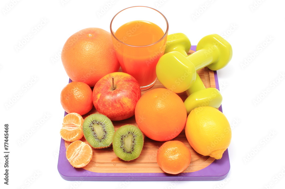 Fresh fruits, dumbbells and glass of juice Fresh fruits, dumbbells and glass of juice