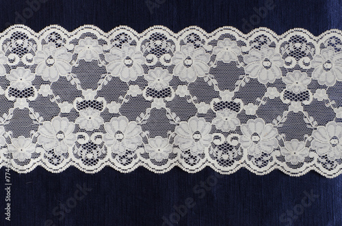 floral lace on the blue silk satin fabric