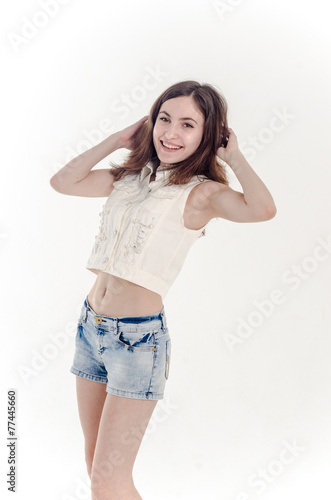Cheerful young teen girl in denim shorts Stock Photo | Adobe Stock