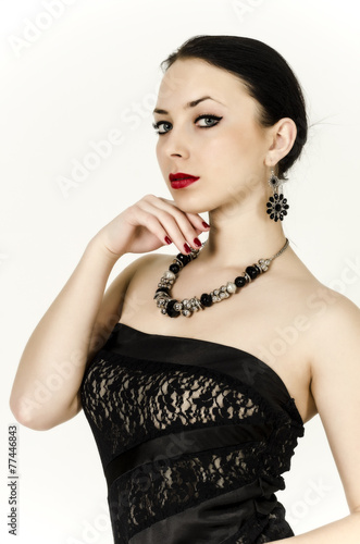 Portrait of a beautiful young brunette woman in a black dress