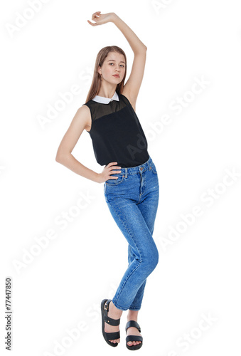 Young fashion girl in jeans posing isolated