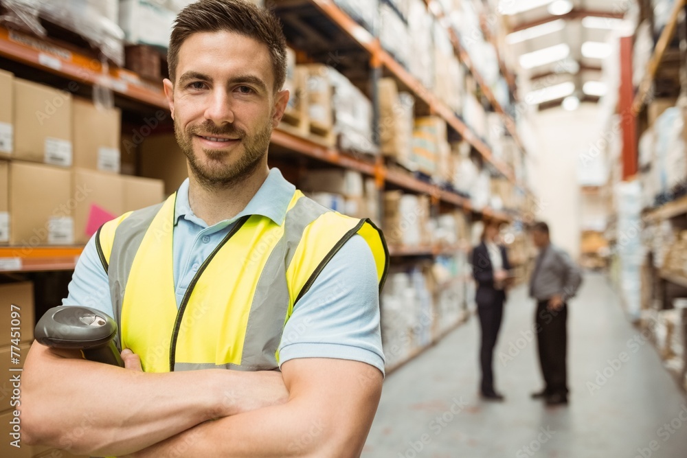 Smiling worker standing with arms crossed Smiling worker standing with arms crossed