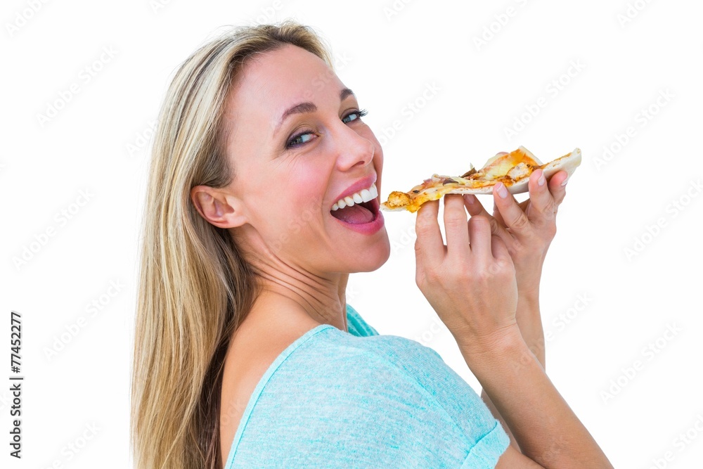 Smiling blonde eating slice of pizza Smiling blonde eating slice of pizza