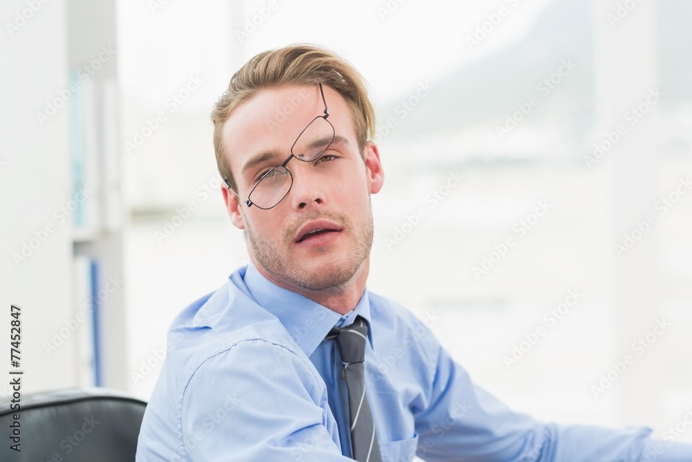 Tired businessman with glasses waking up Tired businessman with glasses waking up