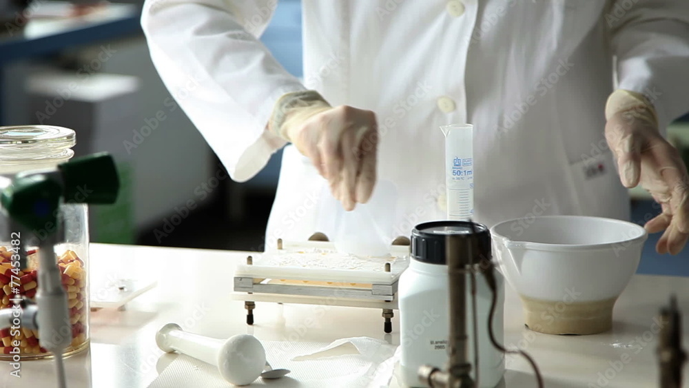 Shot of the young pharmacists making pills Shot of the young pharmacists making pills
