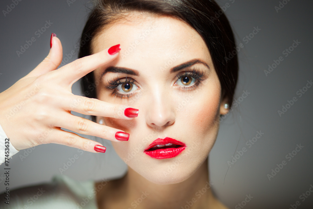 Natural woman face with red nails and lips Natural woman face with red nails and lips