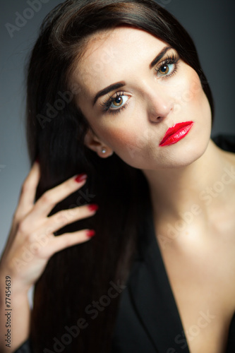 Glamour woman with dark long hair  red lips and nails