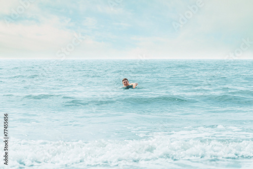 Happy man swimming in the sea