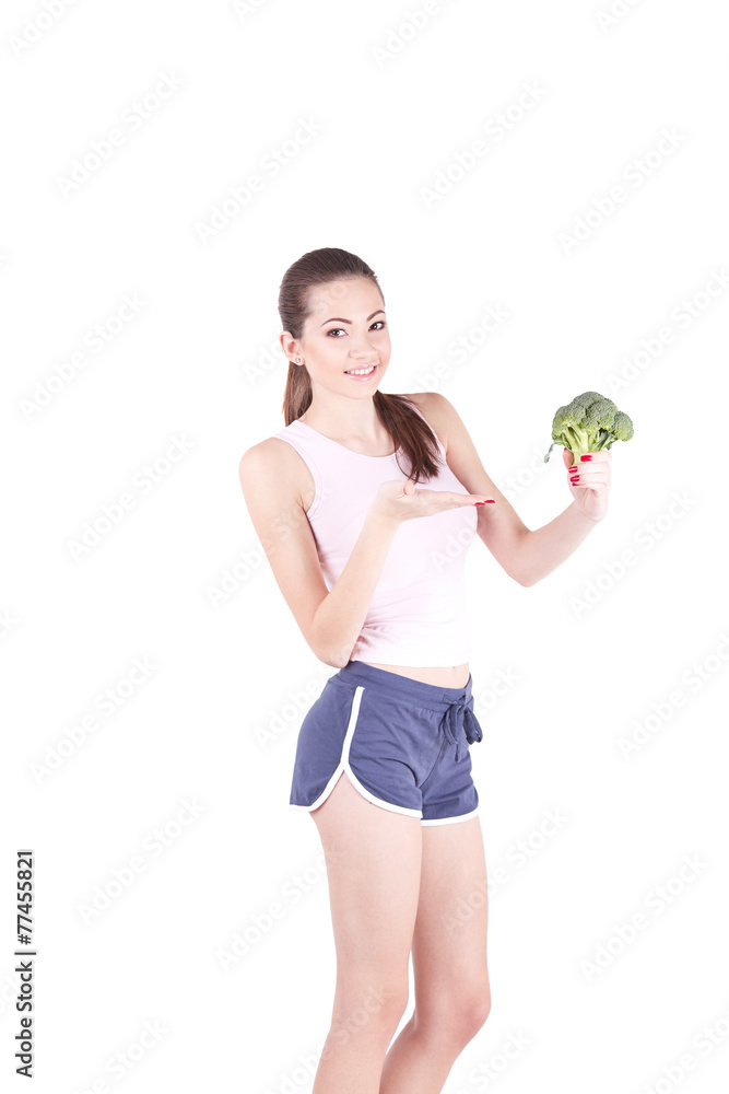 Pretty young woman smiling while holding some broccoli! Pretty young woman smiling while holding some broccoli!
