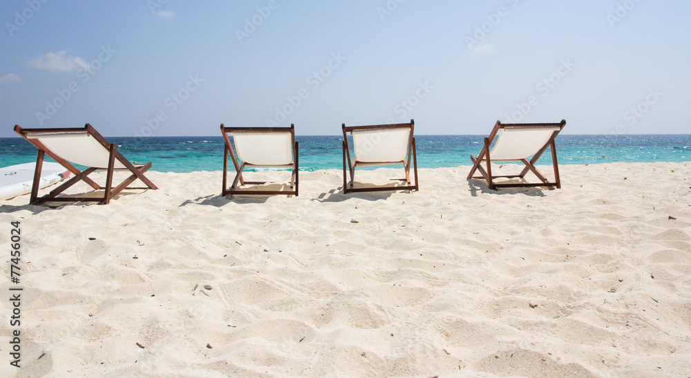 Beach chairs on sand beach