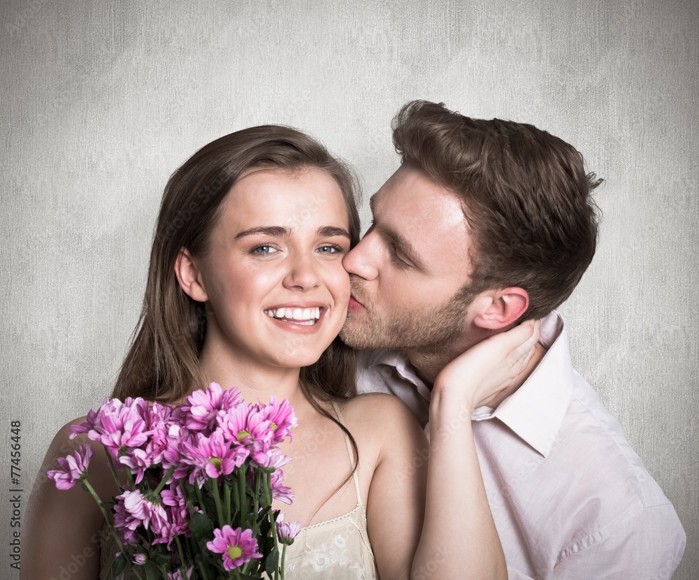 Composite image of man kissing woman as she holds flowers Composite image of man kissing woman as she holds flowers