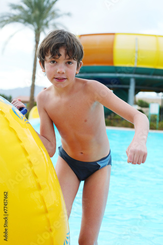 preteen little boy in open air aqua park