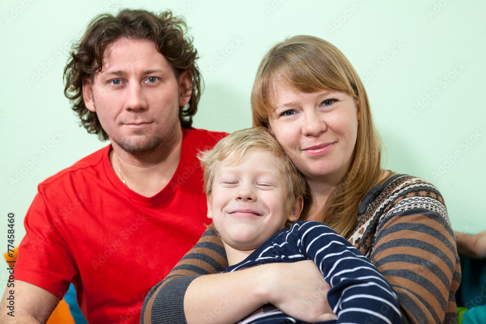 Happy Caucasian embracing family portrait with smiling son