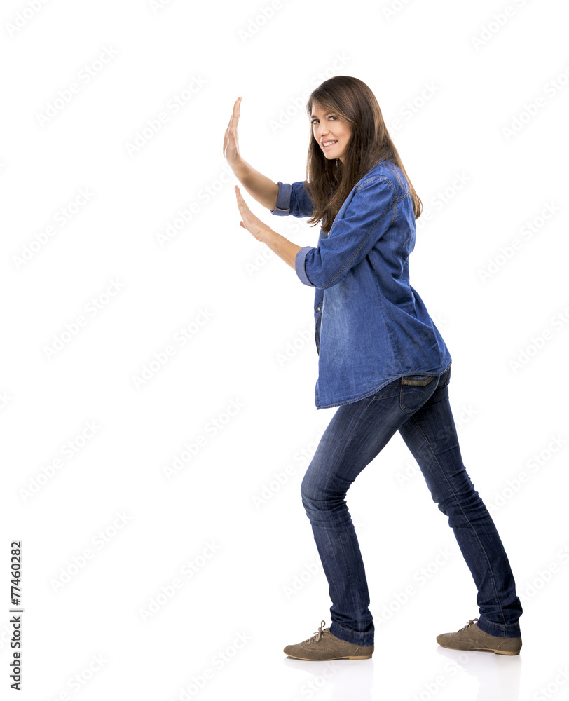 Beautiful woman push something over a white background Beautiful woman push something over a white background