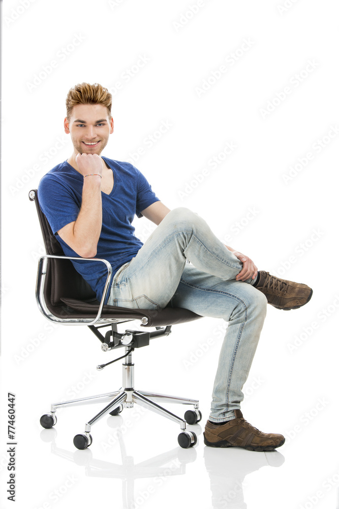 Young man sitting on a chair Young man sitting on a chair