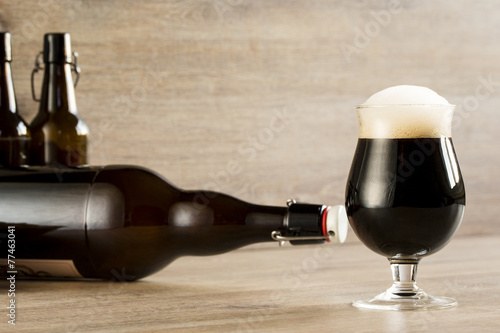 a glass brown beer, on the table
