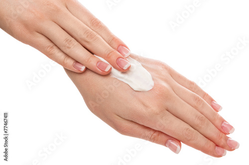 Woman applying moisturizer cream on hands