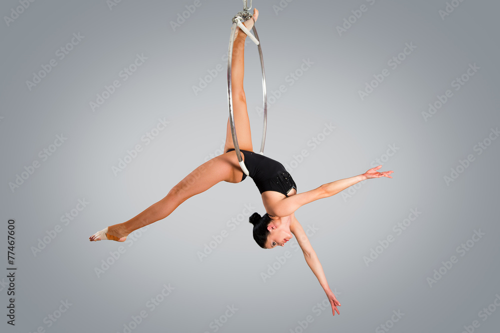 Fototapeta premium Plastic beautiful girl gymnast on acrobatic circus ring in flesh