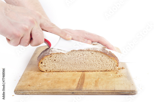 Bread cut hands ceramic knife on a white background
