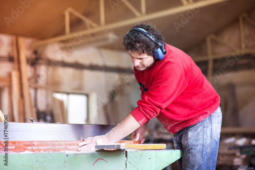 Carpenter working with wood planer