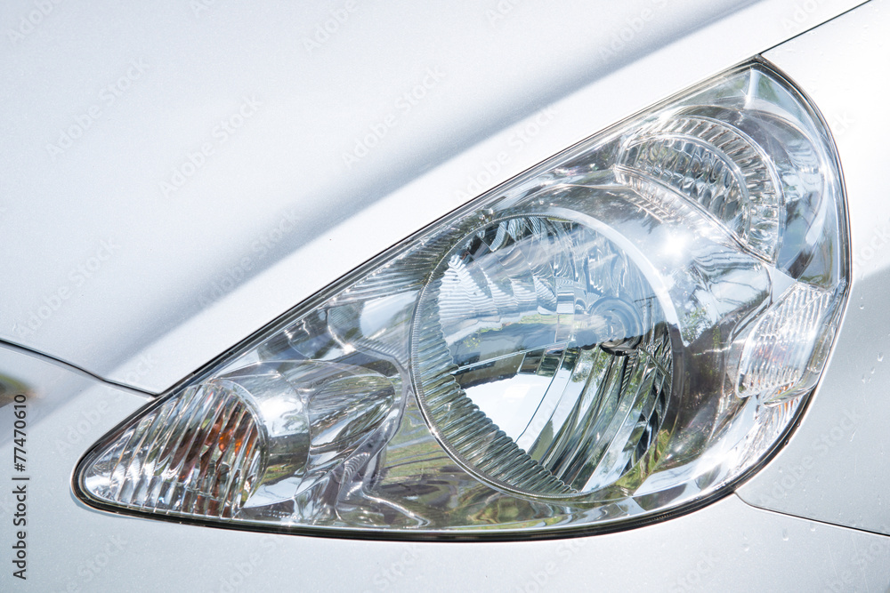 closeup of silver car headlight