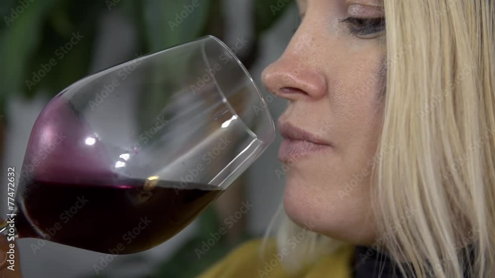 Close shot of expectant mother making a small sip of red wine Close shot of expectant mother making a small sip of red wine