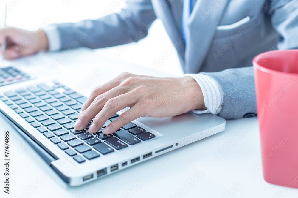 Closeup of businessman hands typing on laptop computer Closeup of businessman hands typing on laptop computer