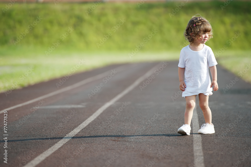 cute girl running at stadium photo