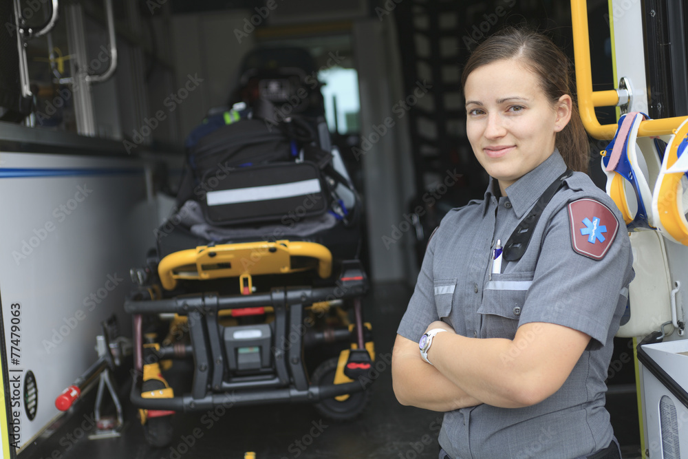 Paramedic employee with ambulance in the background. Paramedic employee with ambulance in the background.