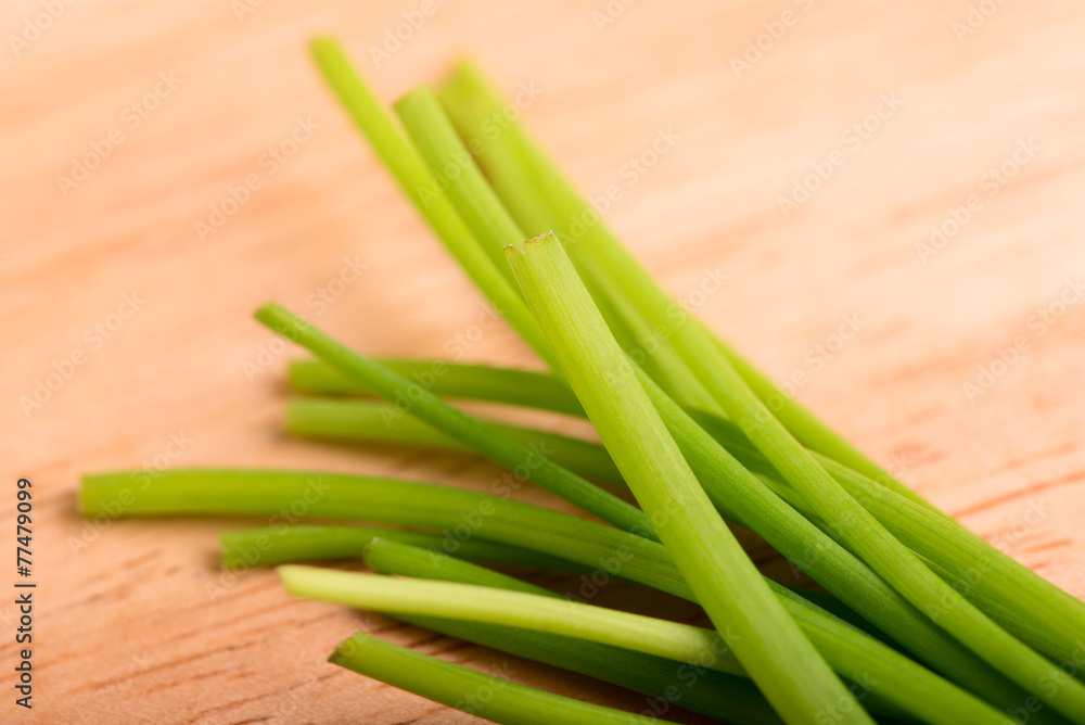 chives close up on a wooden table - selective focus chives close up on a wooden table - selective focus