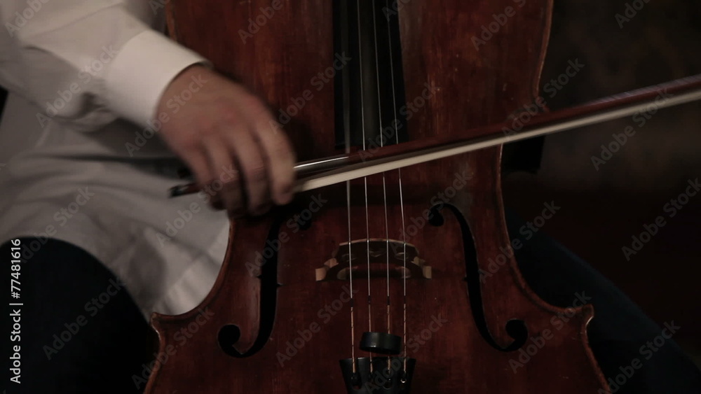 Close up pan shot of a cello player Close up pan shot of a cello player