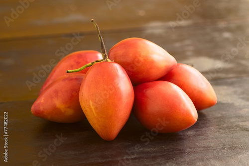 Pile of tamarillo fruits (lat. Solanum betaceum) photo