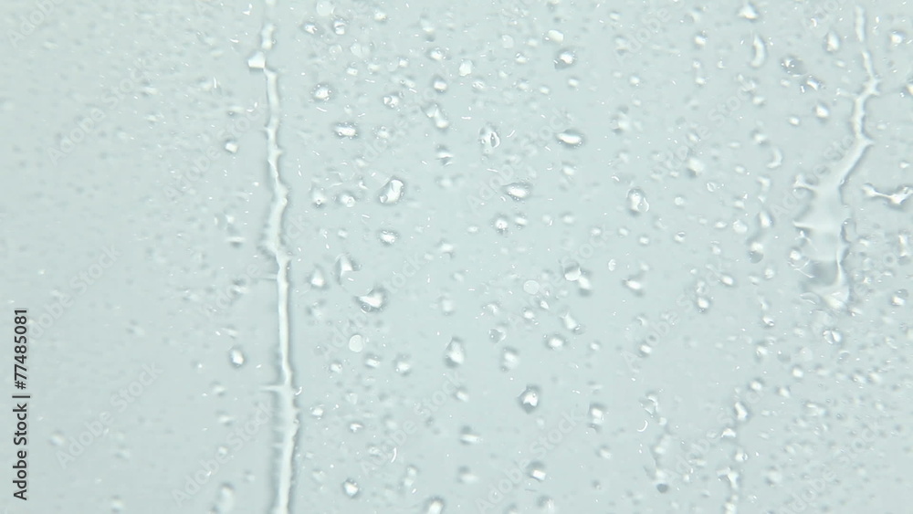 Close up of water drops running on glass Close up of water drops running on glass