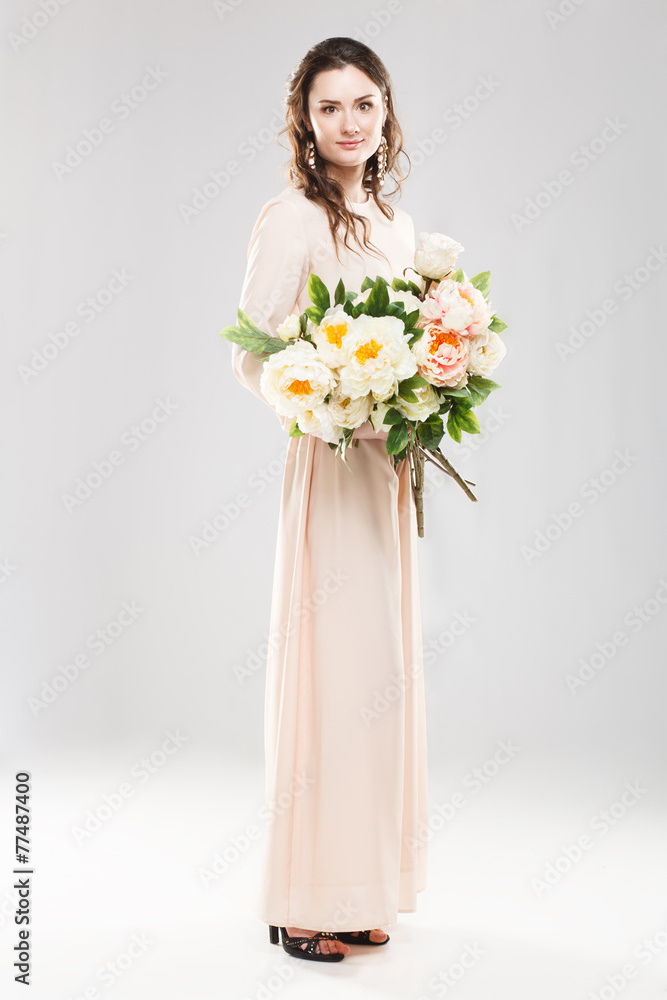 Young beautiful woman with a bouquet of flowers