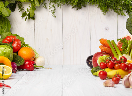 Fototapeta Naklejka Na Ścianę i Meble -  frame with fresh organic vegetables and fruits on wooden backgro