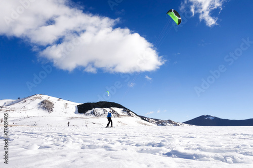The snowkiting is sliding on the snow-covered valley © BlackMac