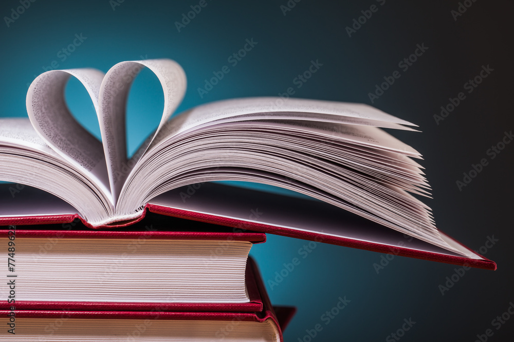 pile of books and magnifying glass on wooden table pile of books and magnifying glass on wooden table