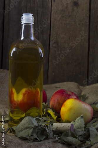 Apples and a bottle of oil