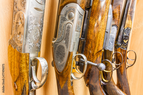 close up of a row of guns displayed in gun shop