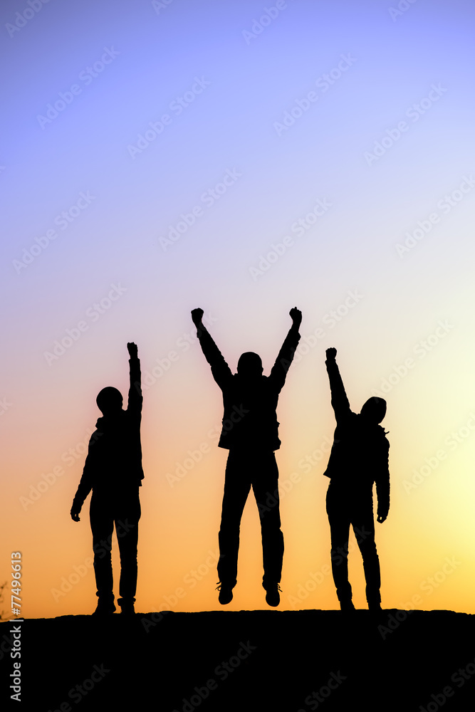 Silhouette of the team on the peak of mountain