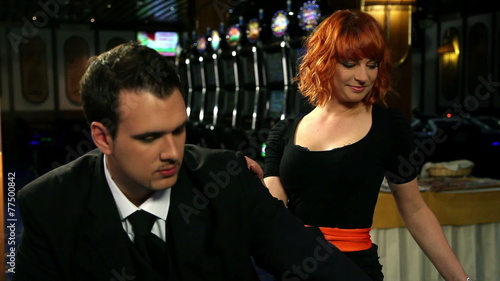 Young and attractive couple playing and winnig roulette in casino photo