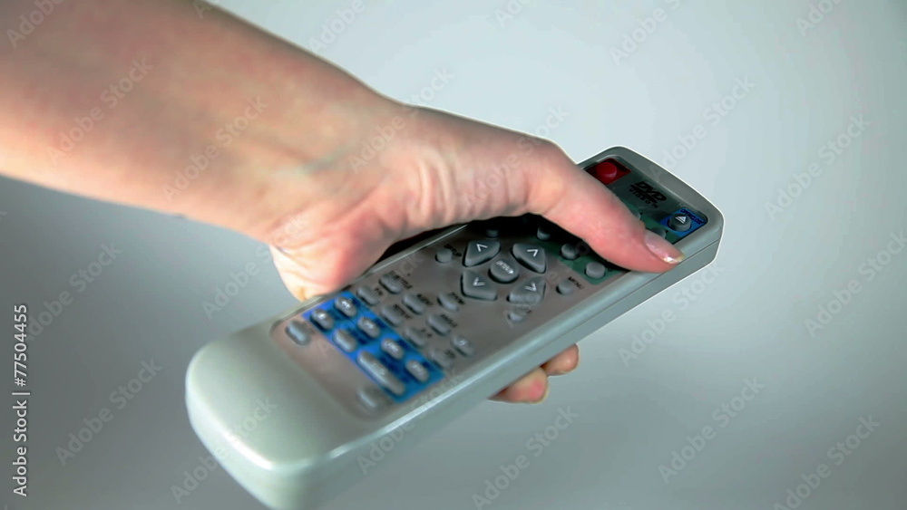 Close up shot of a hand holding remote Close up shot of a hand holding remote