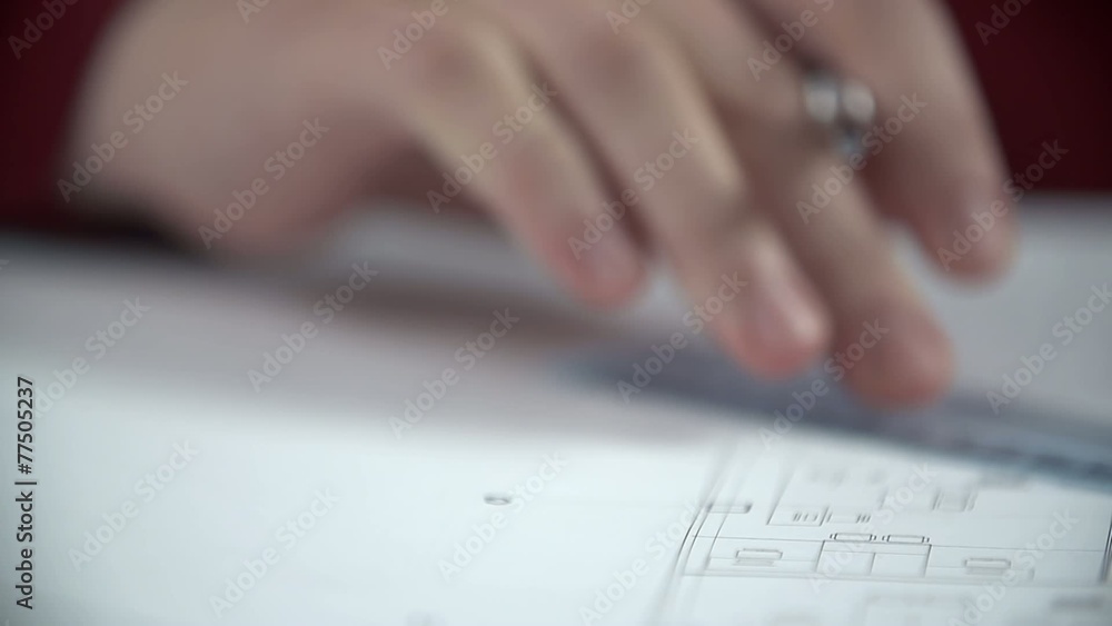 Hands draw lines with biro using the ruler