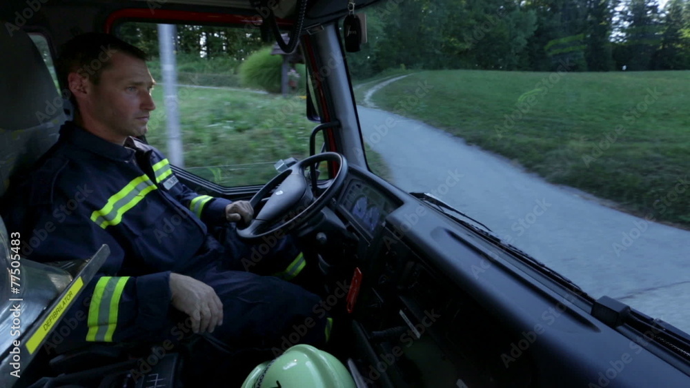 Fireman in a cabin driving a truck Fireman in a cabin driving a truck