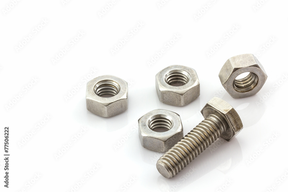 Metal screw and nuts on white background. Metal screw and nuts on white background.