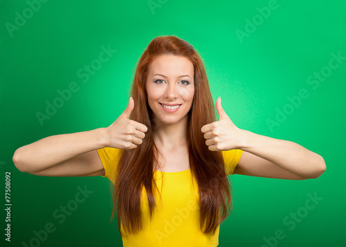 Happy smiling woman with thumbs up gesture green background 
